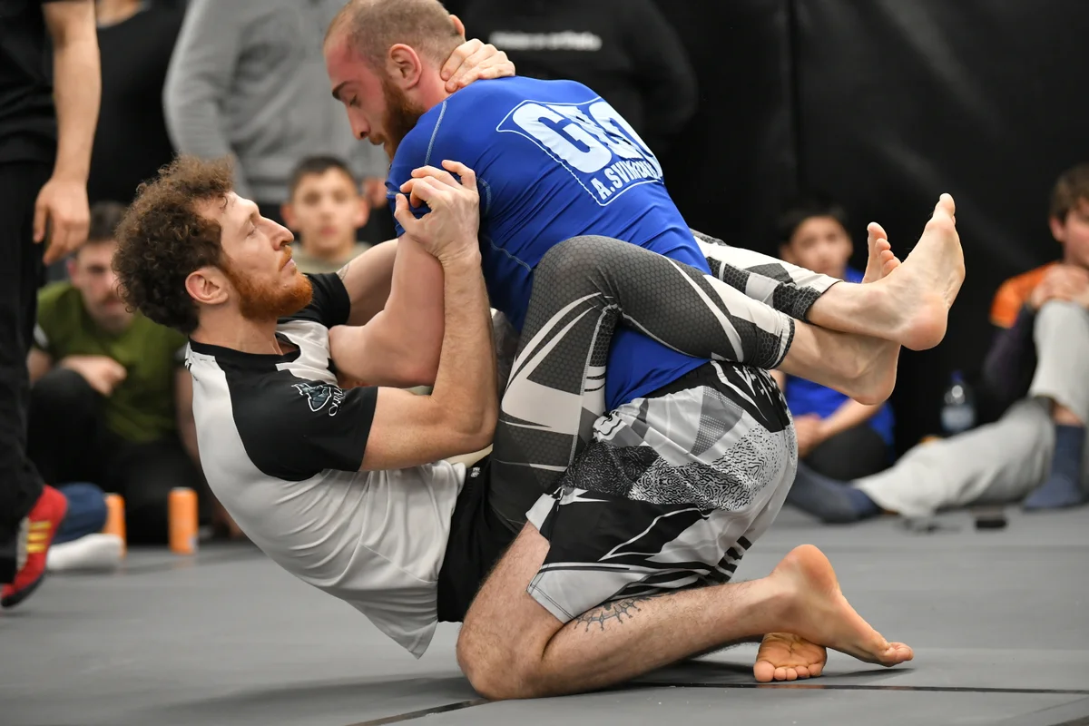 Two BJJ athletes hand fighting during an intense training round