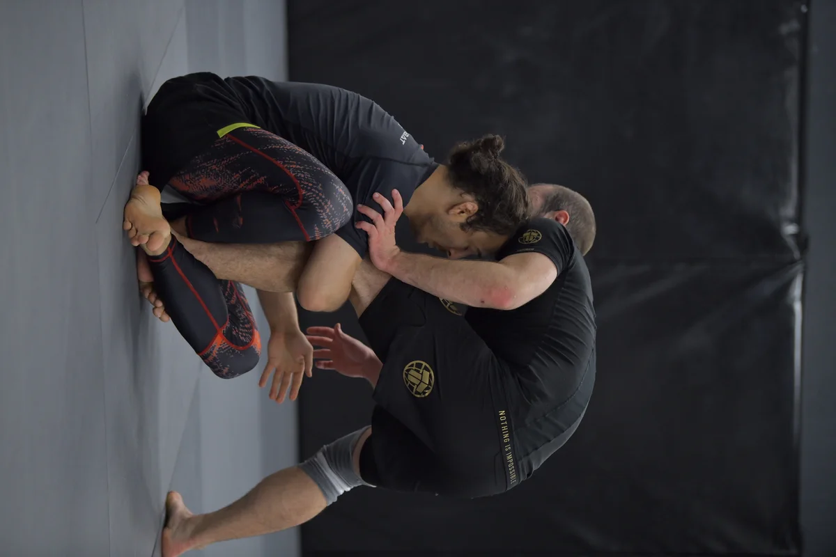 No-Gi grapplers training on the mat during BJJ camp