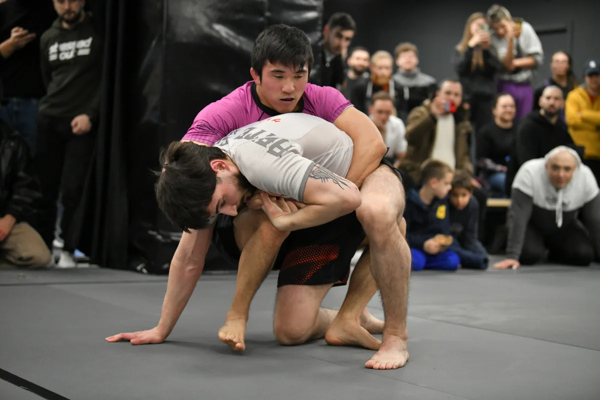 Adult grapplers fighting for position during competition training